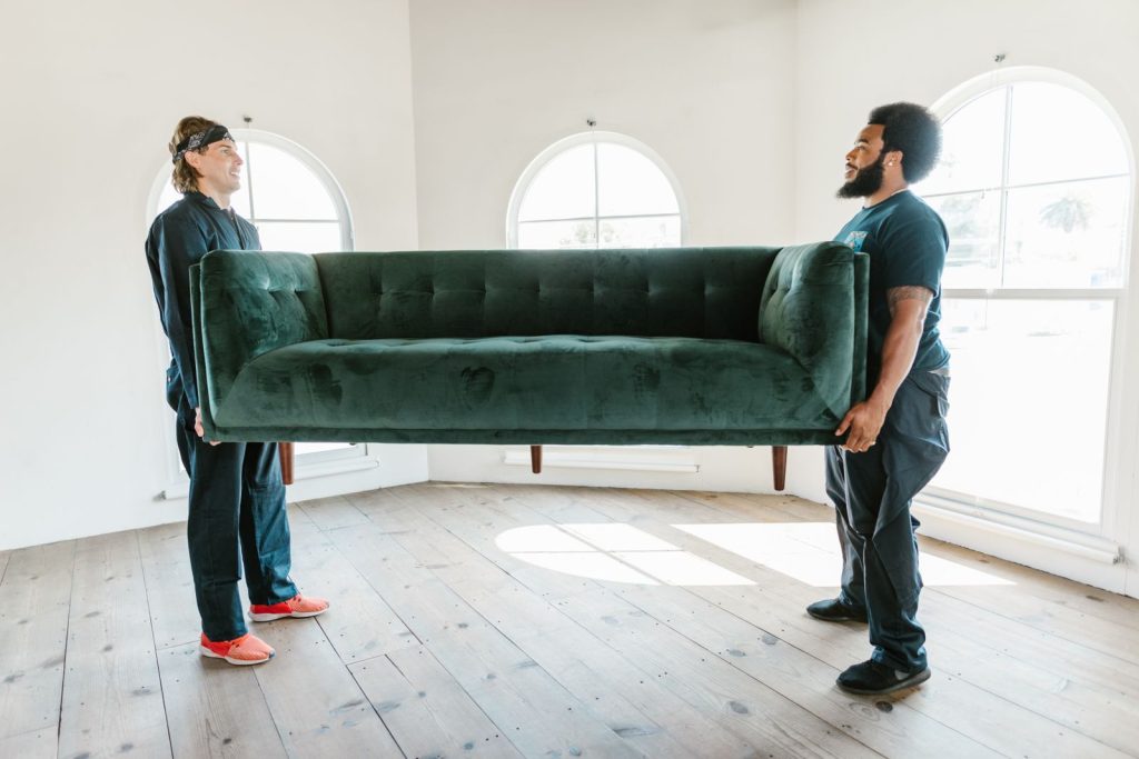 Legend Movers crew carrying a sofa during a Dallas home move