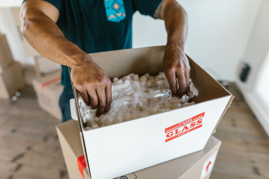 Breakables wrapped and packed into a labeled moving box