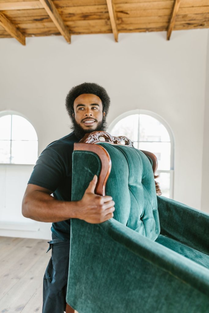 Legend Movers mover carrying a padded armchair on a Dallas move